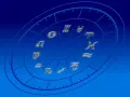 Złote symbole znaków zodiaku na tle niebieskiej tarczy. Czy znaki zodiaku to grzech? Zastanówmy się nad tym, patrząc na te mistyczne symbole.