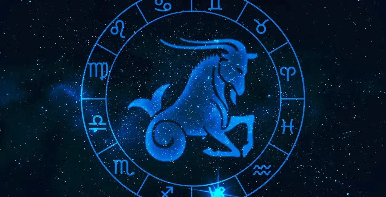 Błękitny koziorożec w centrum zodiaku, otoczony symbolami gwiazd. Byk i koziorożec to znaki zodiaku.