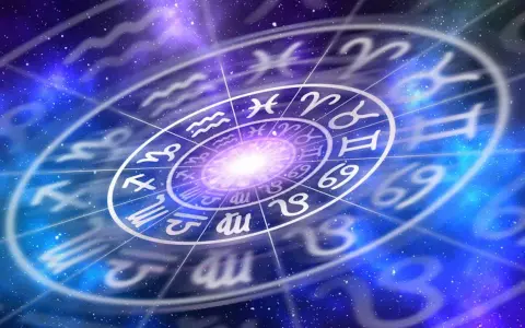 Gwiazdy układają się w krąg zodiaku, gdzie po koziorozcu w zodiaku widać symbole innych znaków na tle kosmicznej mgławicy.