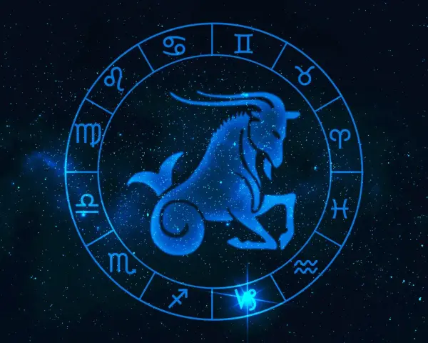 Błękitny koziorożec w centrum zodiaku, otoczony symbolami gwiazd. Byk i koziorożec to znaki zodiaku.