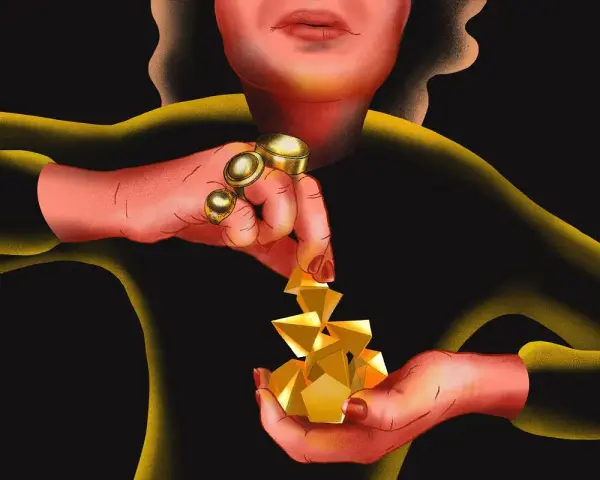 Dłonie z pierścieniami układają złote bryły, przypominające 3 denary tarot.