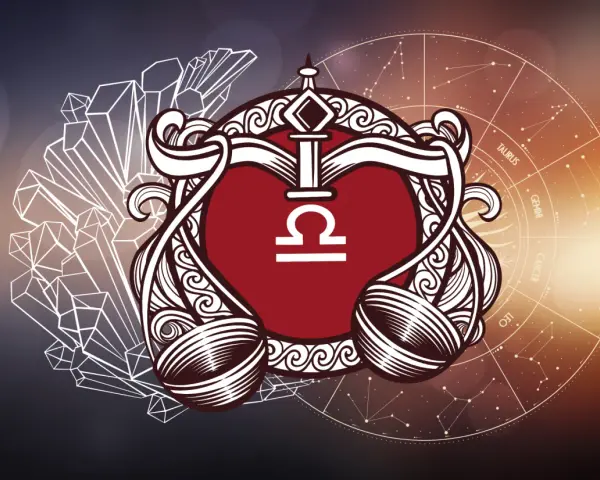 Symbol wagi znak zodiaku w ozdobnej ramie, otoczony kryształami i kołem zodiaku.
