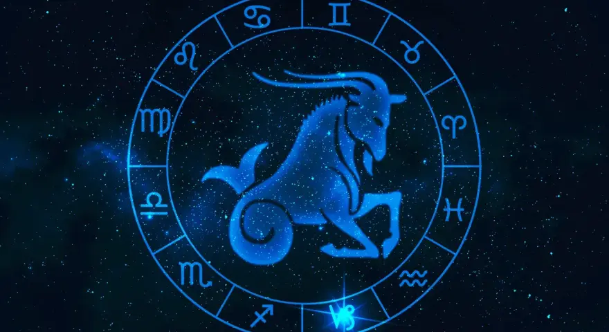 Błękitny koziorożec w centrum zodiaku, otoczony symbolami gwiazd. Byk i koziorożec to znaki zodiaku.